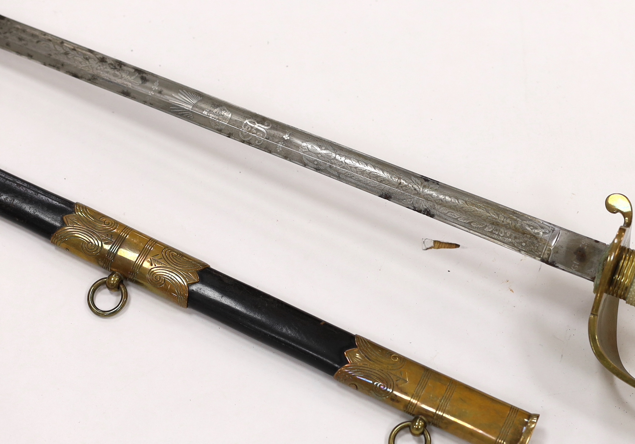 A George V naval officer’s sword, maker Grieves, in a leather scabbard, guard engraved G.P. Bewley, blade 79.5cm, together with outer leather cover